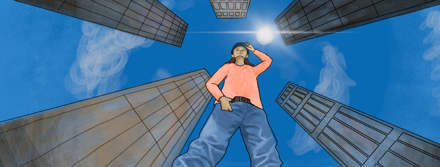 A worm's eye view of an adult holding the brim of a hat. There are skyscrapers towering around them and a bright sun shining overhead.