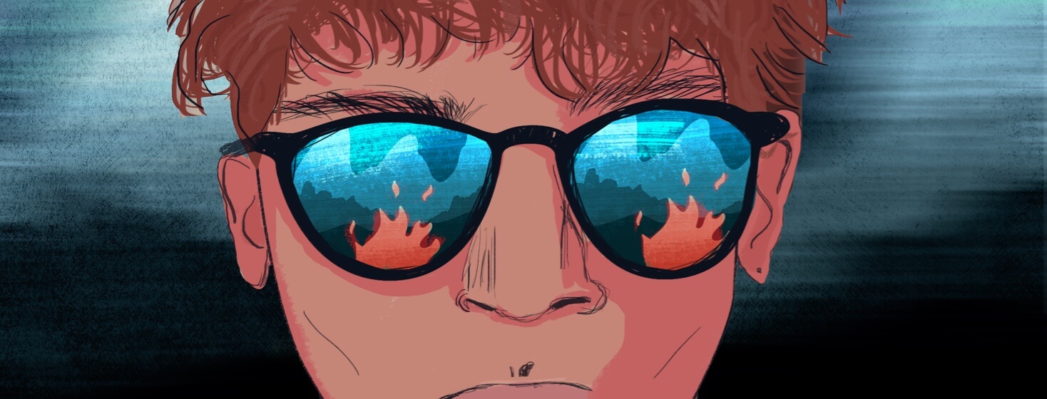 Extreme closeup of a person's face wearing sunglasses with a campfire reflected in the lenses.